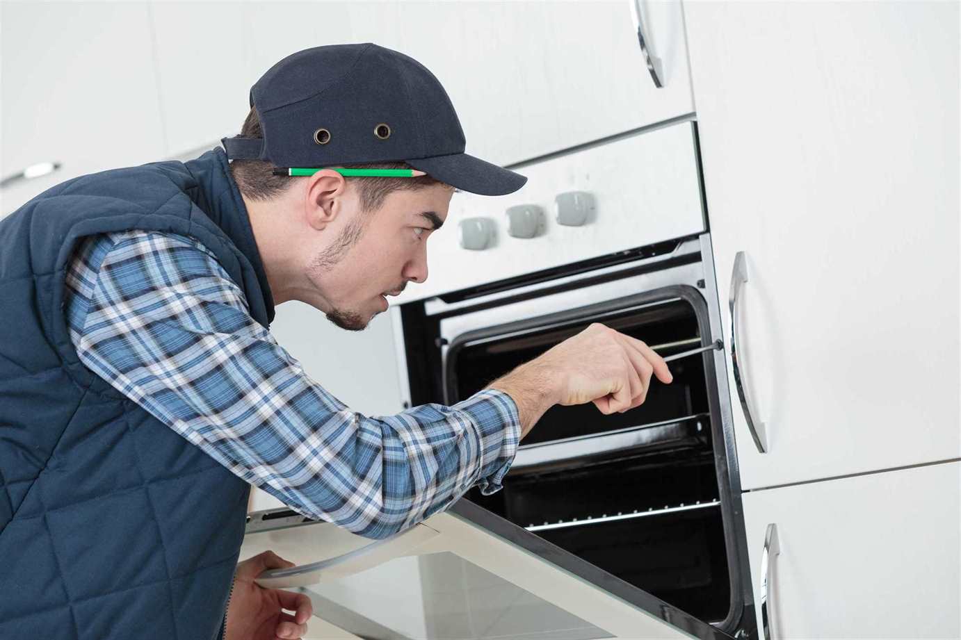 a man fixing the oven