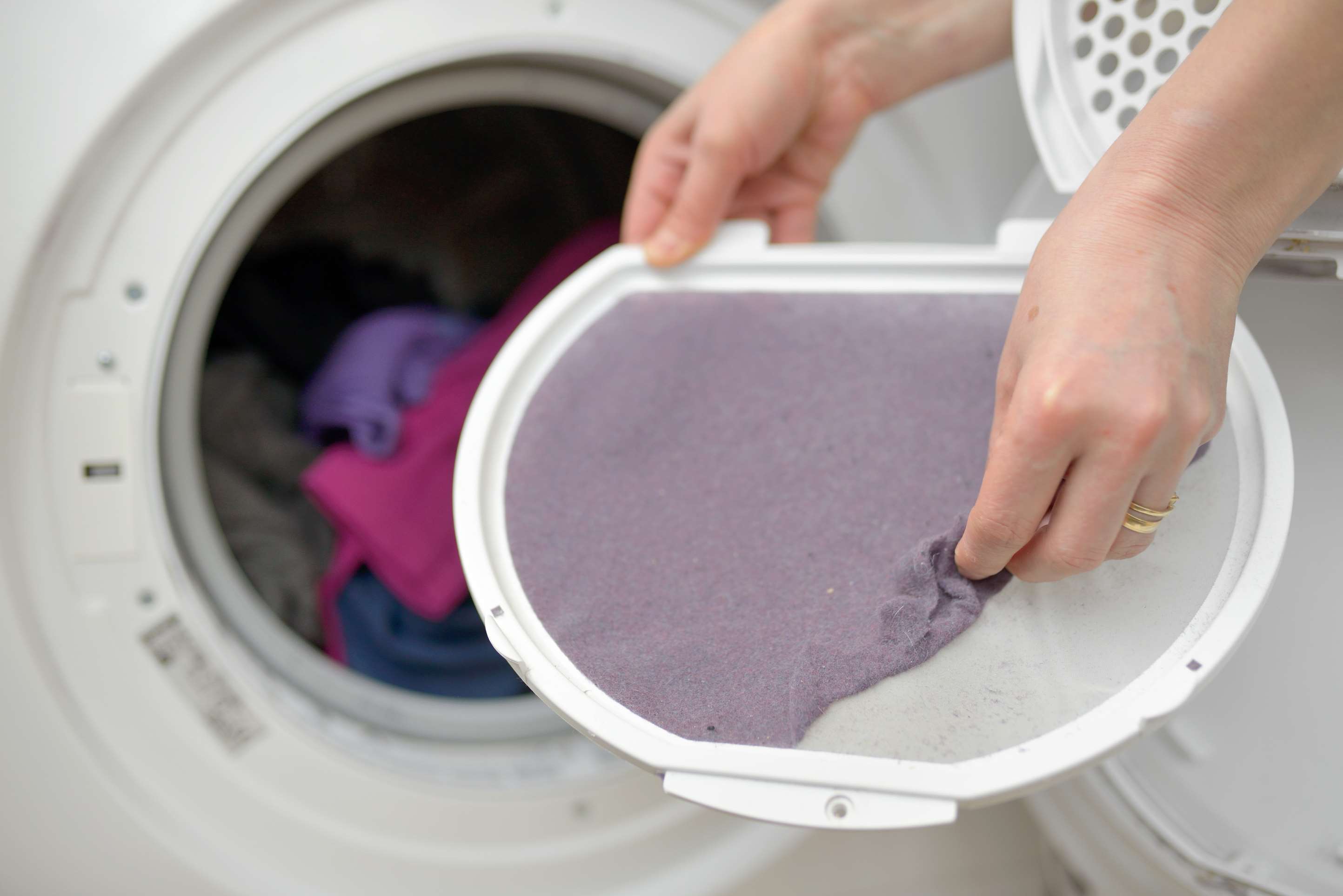 Woman Taking the lent of Dryer Machine