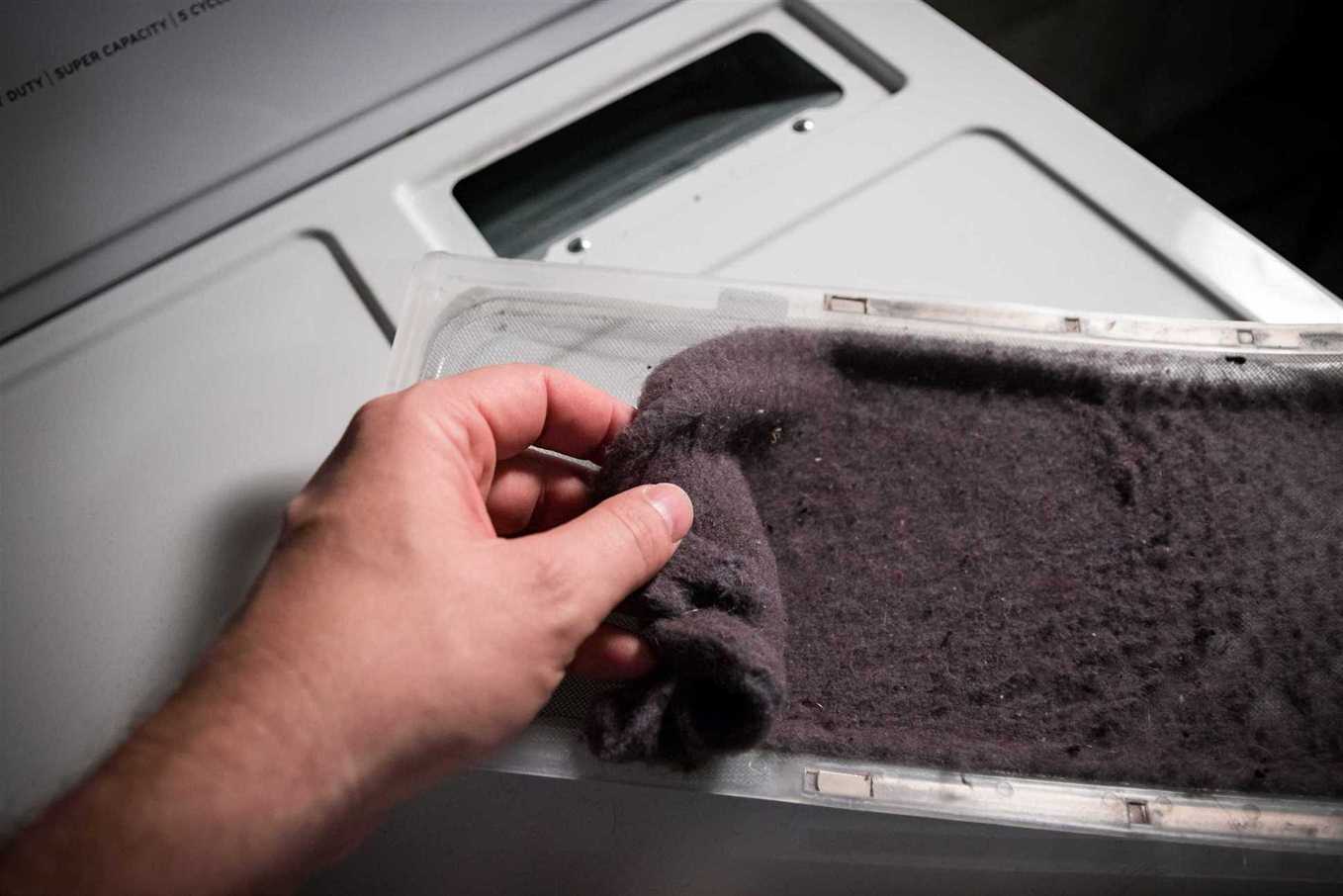 man taking the lent of dryer machine