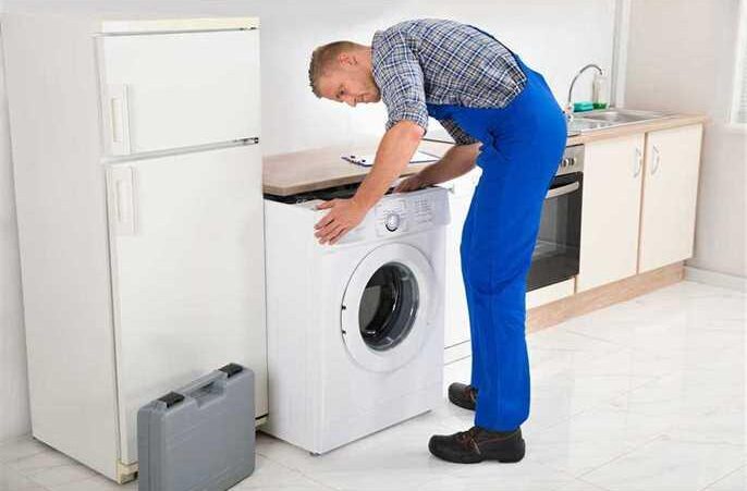 a man installing a washing machine