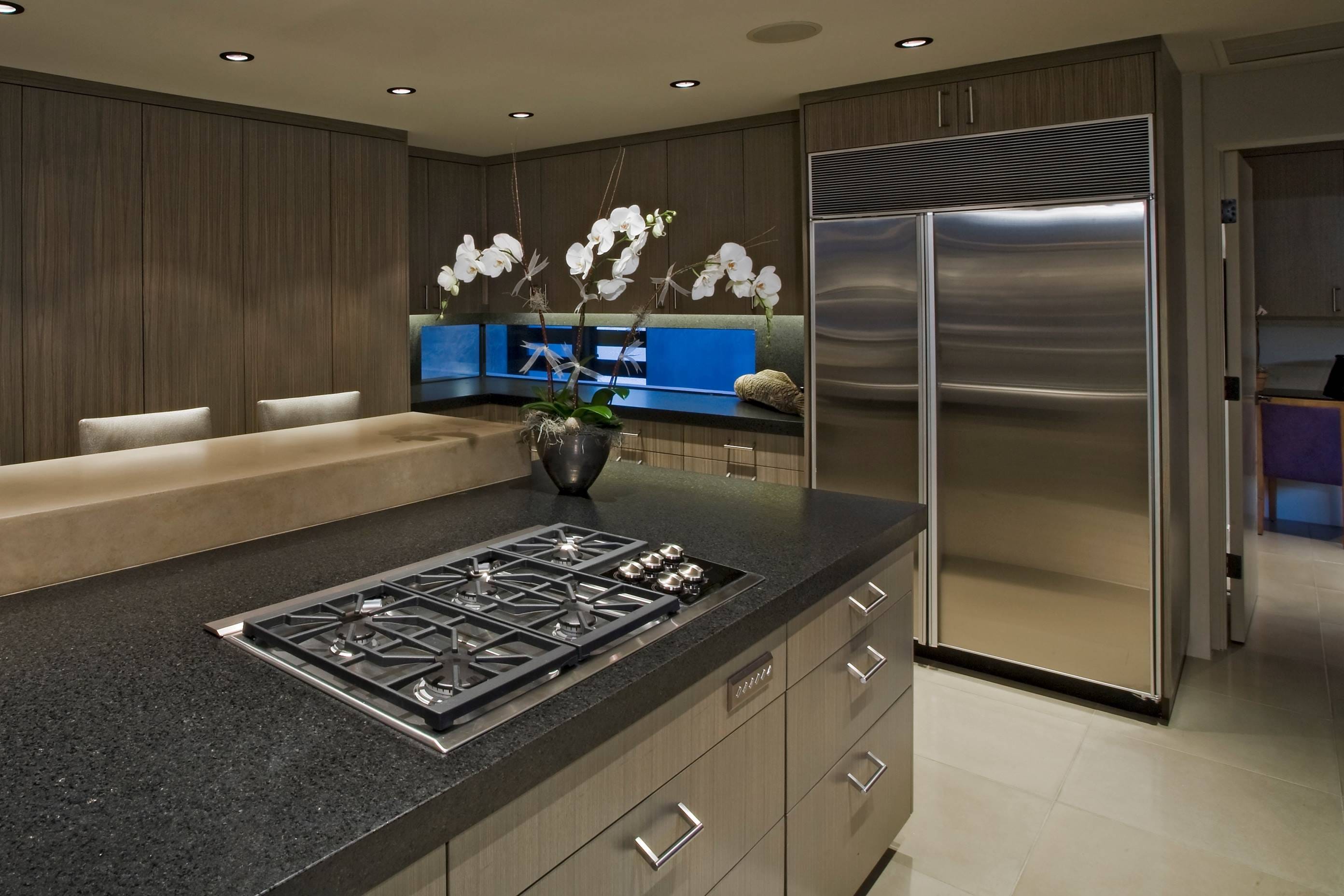 modern kitchen with big installed fridge and stove on the kitchen isle