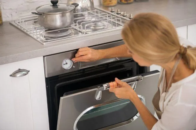 woman cleaning the oven