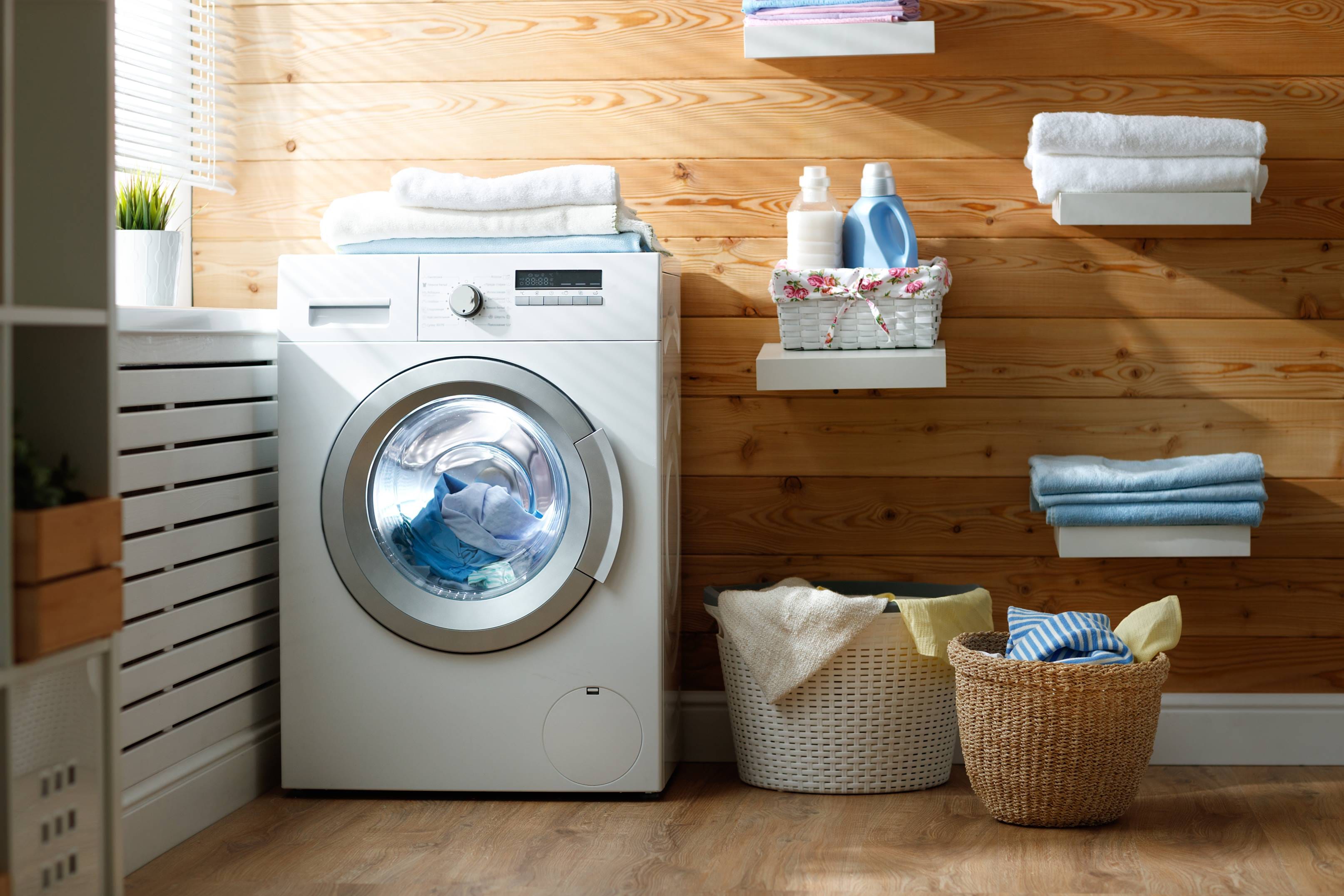 image of a loaded washing machine with folded towels on top