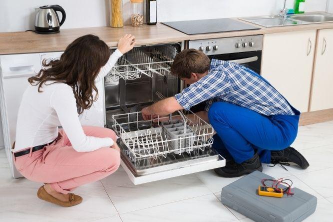 man fixing a dishwasher