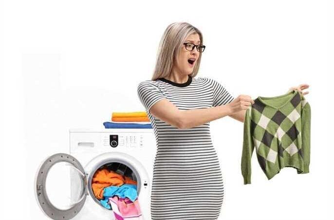 a woman surprised that her sweater shrink after the wash